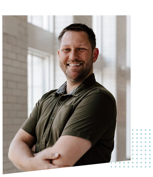 Ross Vollmer smiling with is arms crossed.